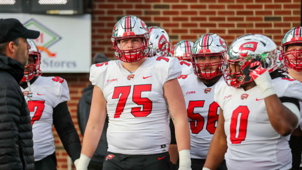 Nov 27, 2021; Huntington, West Virginia, USA; Western Kentucky Hilltoppers offensive lineman Gunner Britton (75) leads the team onto the field prior to their game against the Marshall Thundering Herd at Joan C. Edwards Stadium. Mandatory Credit: Ben Queen-USA TODAY Sports